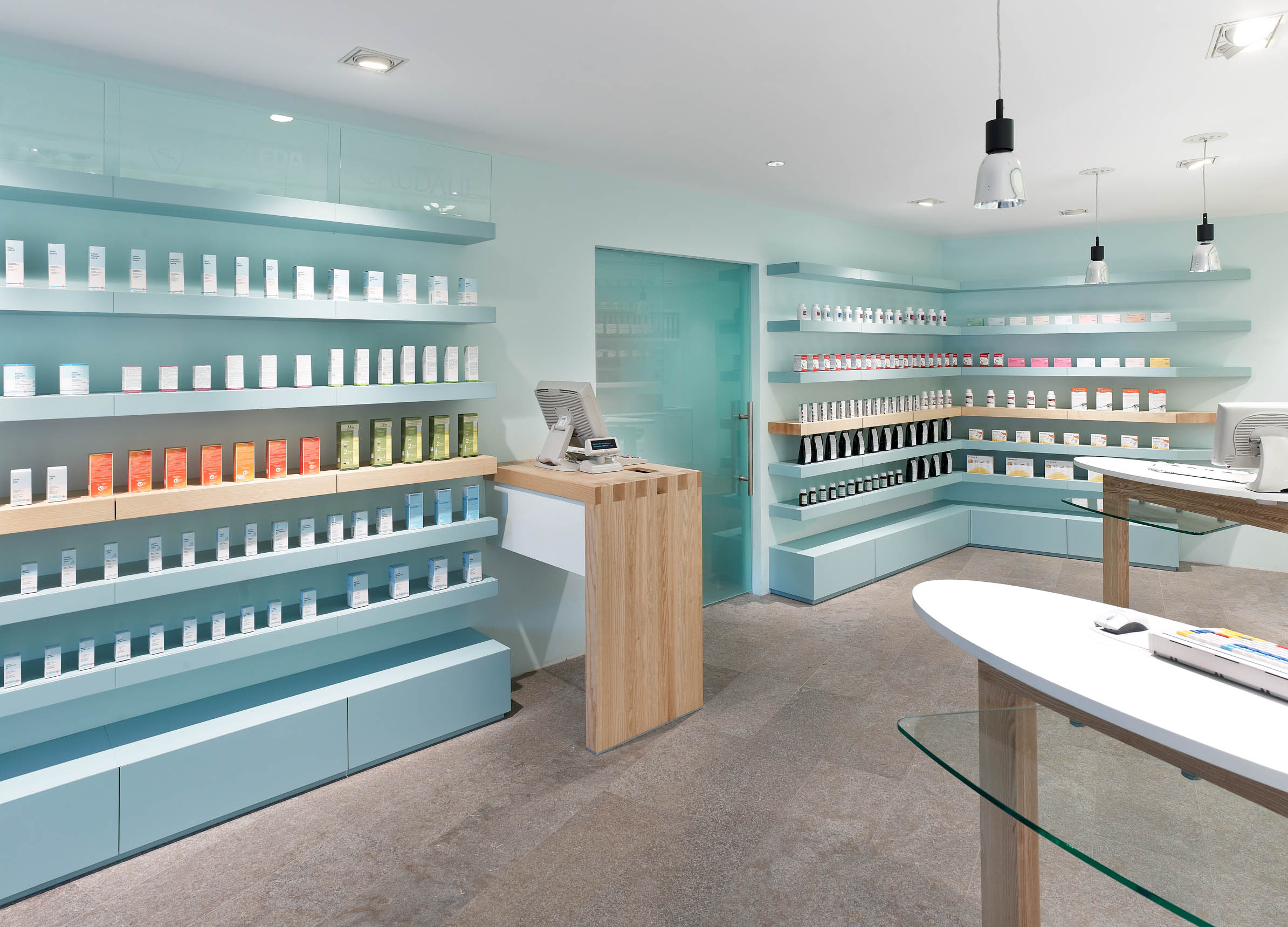 Self-service area with soft blue tones, ash wood and express prescription counter