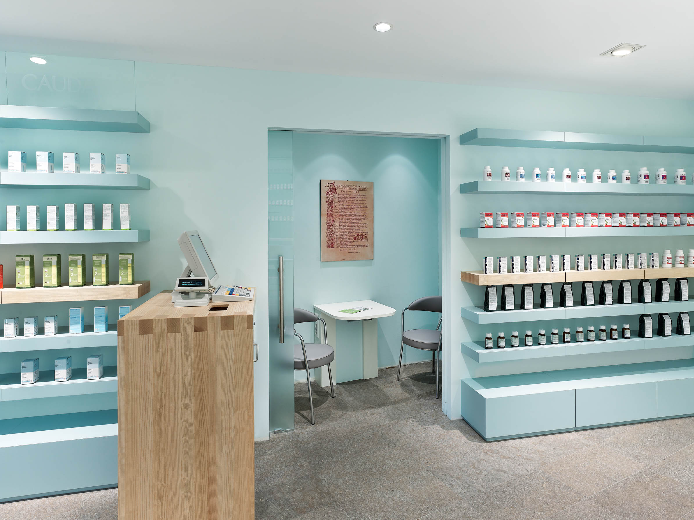 Consultation room behind the self-service area with express prescription counter