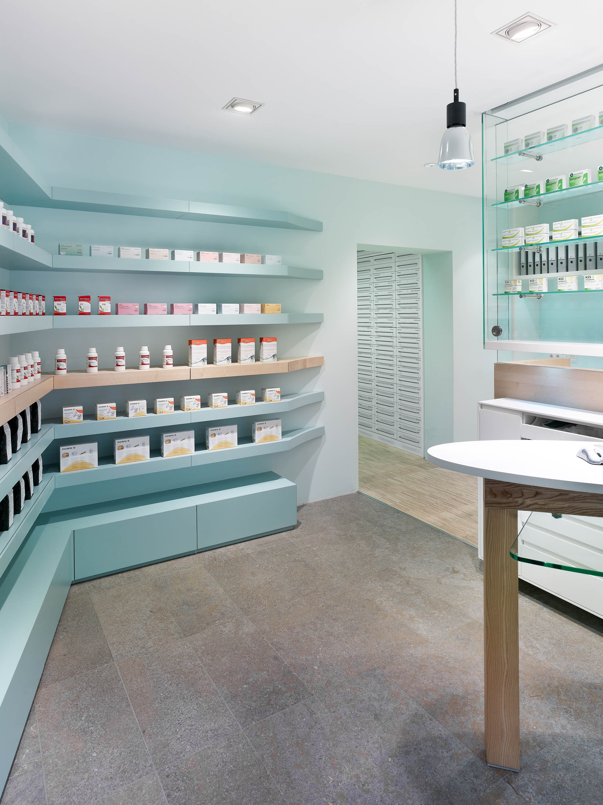 Self-service area with passage to the working area and drawer columns