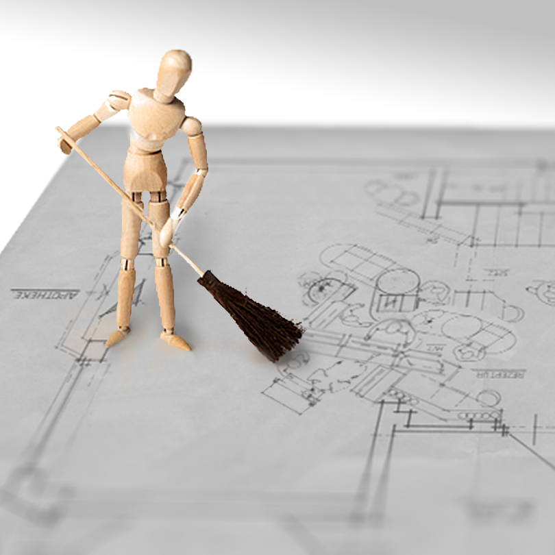 Wooden figure with a broom standing on a floor plan